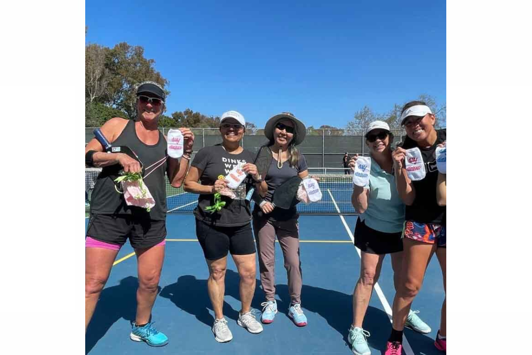 group of women pickleball players holding sockprints pickleball socks