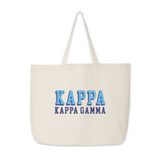 Kappa Kappa Gamma tote bag with standout 3D lettering on natural canvas, photographed on white.