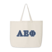 Alpha Epsilon Phi canvas tote with denim Greek letters displayed neatly on a table