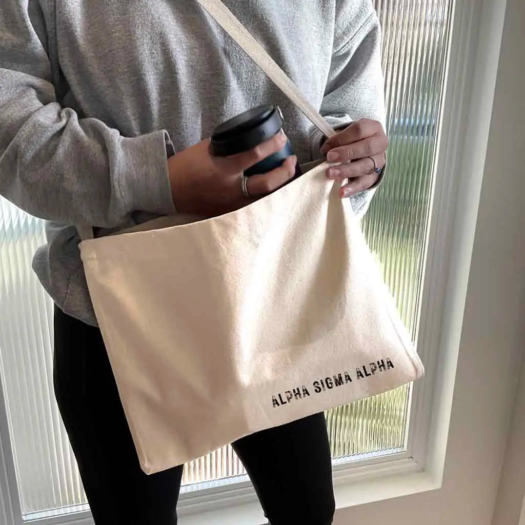 Crafted from durable canvas, each spacious bag features the Alpha Sigma Alpha name digitally printed on both sides in the lower corner. Perfect for all your essentials, this carry-all silhouette is a fantastic gift idea and a favorite for chapter orders and big-little gifts.