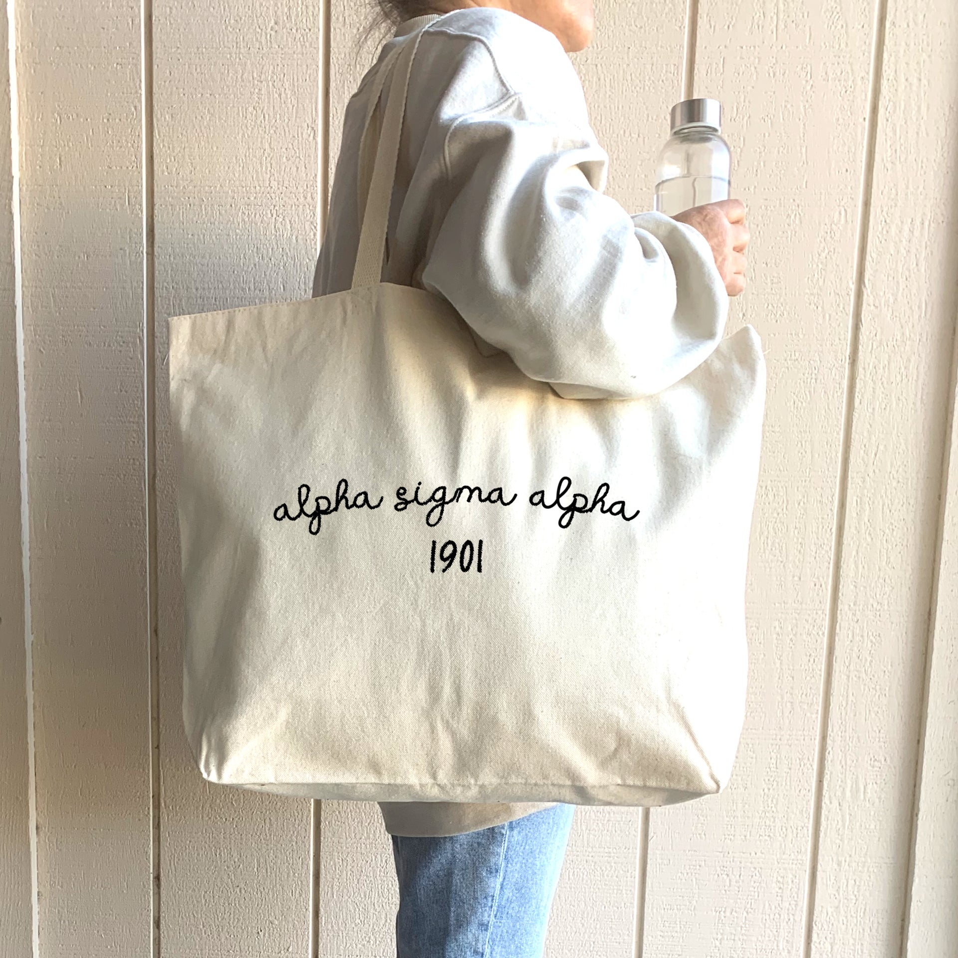 Alpha Sigma Alpha – A student models an Alpha Sigma Alpha sorority tote bag, casually slung over her shoulder as she walks through campus.