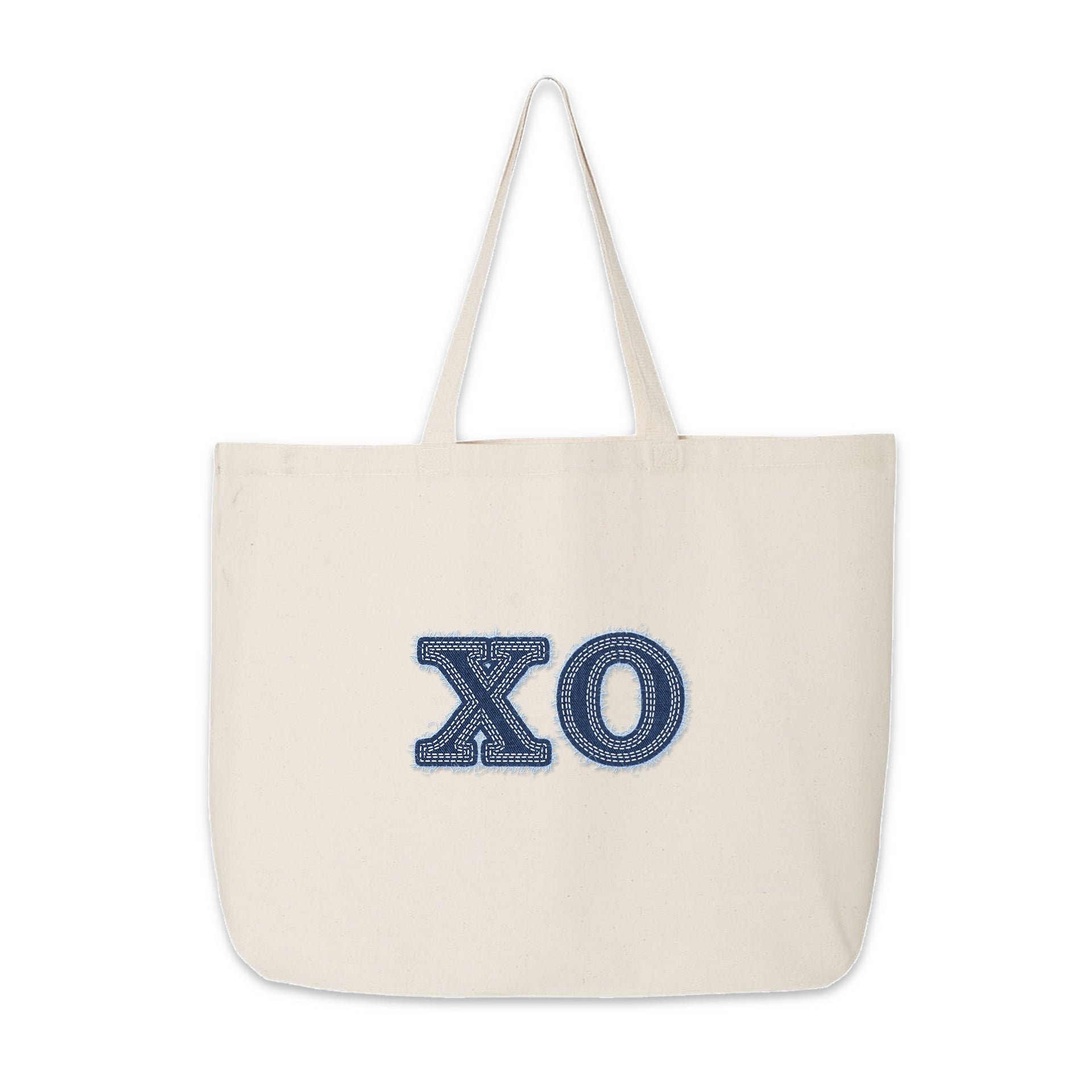 Chi Omega tote bag with denim-style letters placed flat for product display