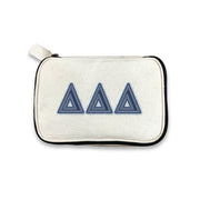 Delta Delta Delta cosmetic bag with Tri-Delta denim-style Greek letters on canvas, photographed against white.