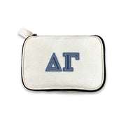 Delta Gamma cosmetic bag with DG denim-style Greek letters on canvas, photographed against white.