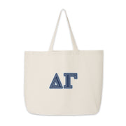Clean product shot of the Delta Gamma tote with denim-style letters.