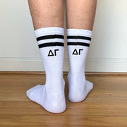 White crew socks with black stripes and "??" Greek letters printed on the back of each leg.