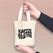 Kappa Alpha Theta mini sorority tote carried by a Theta sister, ideal for daily errands.