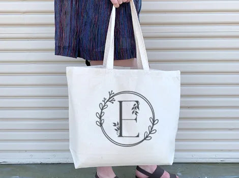 Large cotton canvas tote bags with stylized monograms custom printed on the side. Printed in the USA