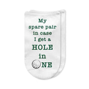 A pair of white no-show golf socks with the phrase "My Spare Pair in Case I Get a Hole in One" printed on top, designed for men golfers. A fun and practical golf gift or tournament prize.