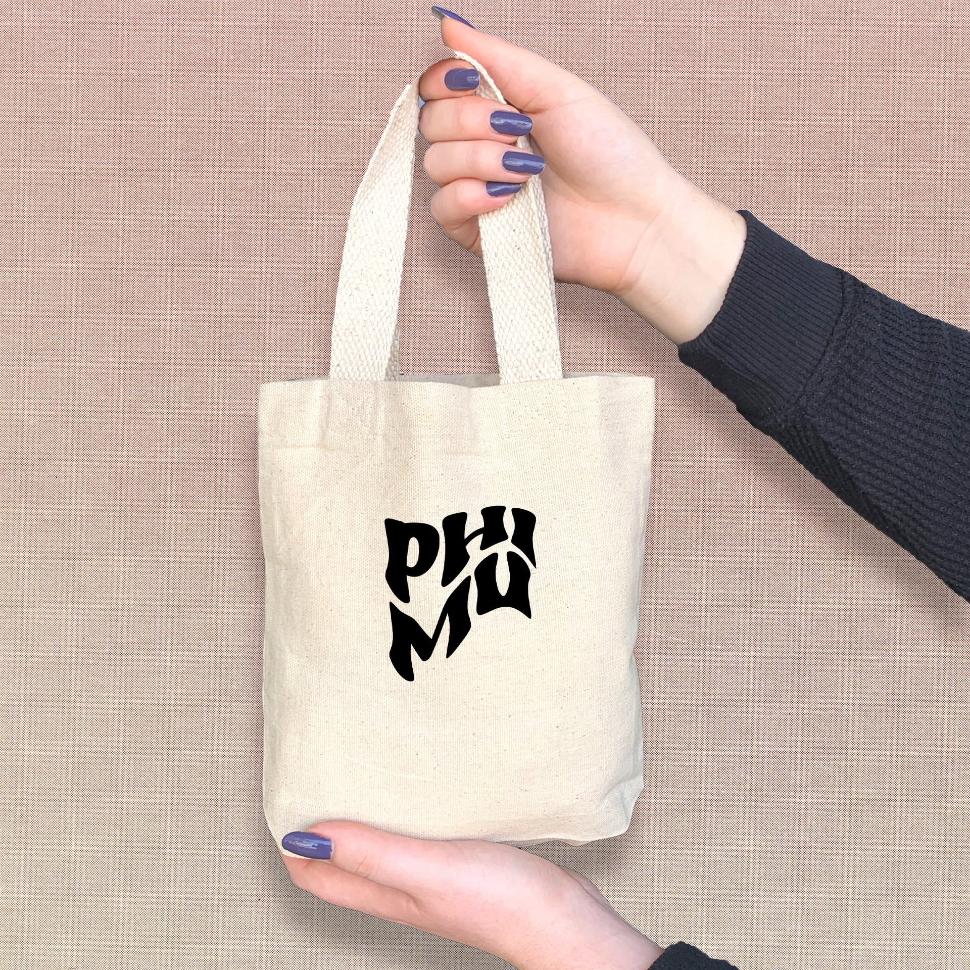 Phi Mu sorority sister with a cute mini tote bag featuring Phi Mu's iconic Greek letters.