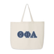 Theta Phi Alpha tote with denim Greek letters shown upright on a plain backdrop.