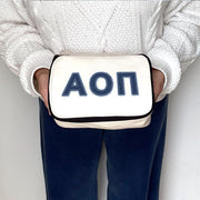 Alpha Omicron Pi makeup bag with AOII letters in a denim-style print, displayed while being held.