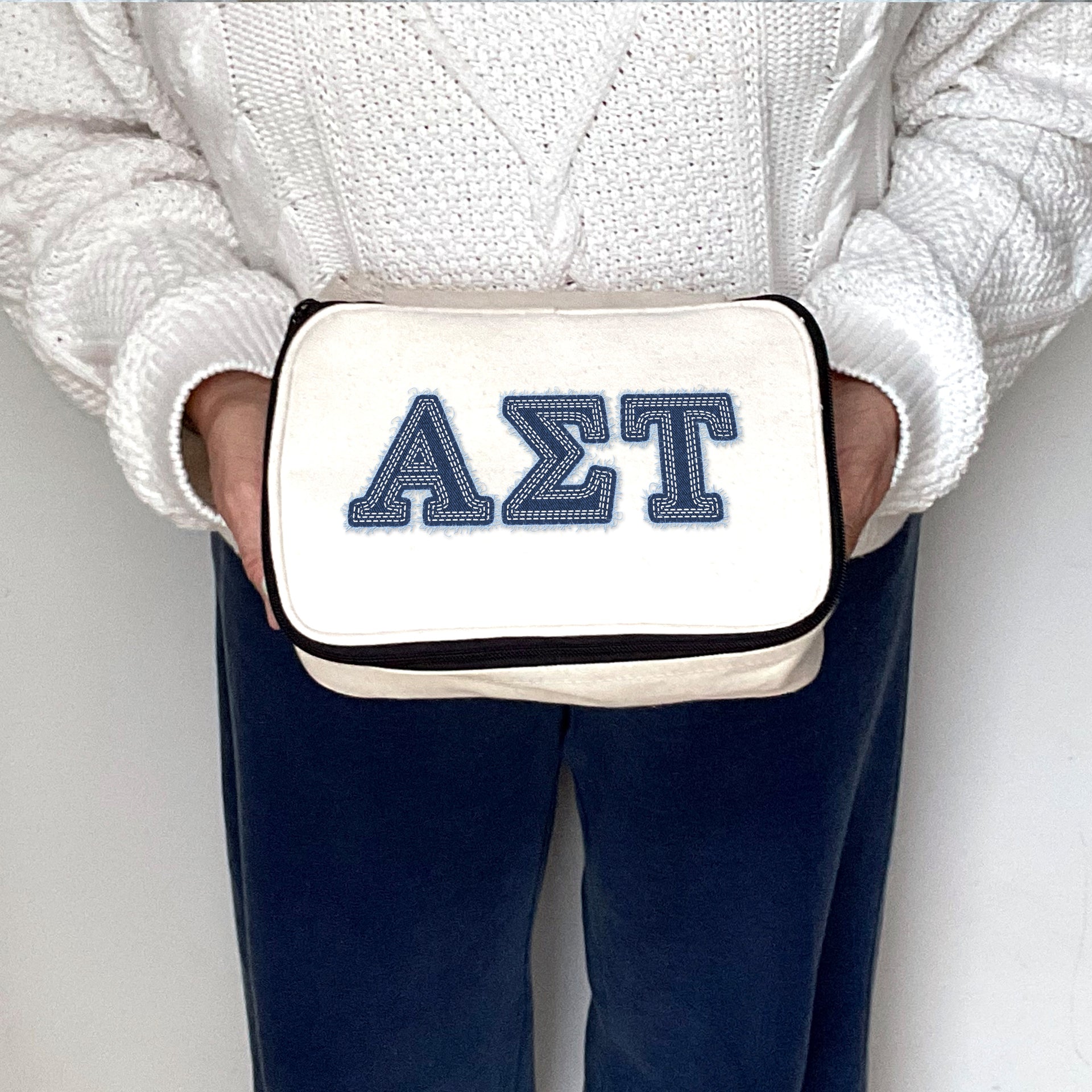 Alpha Sigma Tau cosmetic bag featuring AST Greek letters in a printed denim-style font.