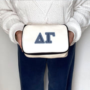 Delta Gamma DG cosmetic bag with denim Greek letters, held and showcased by a sorority member.