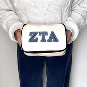 Zeta Tau Alpha ZTA denim-style Greek letter pouch held and showcased by a sorority member.