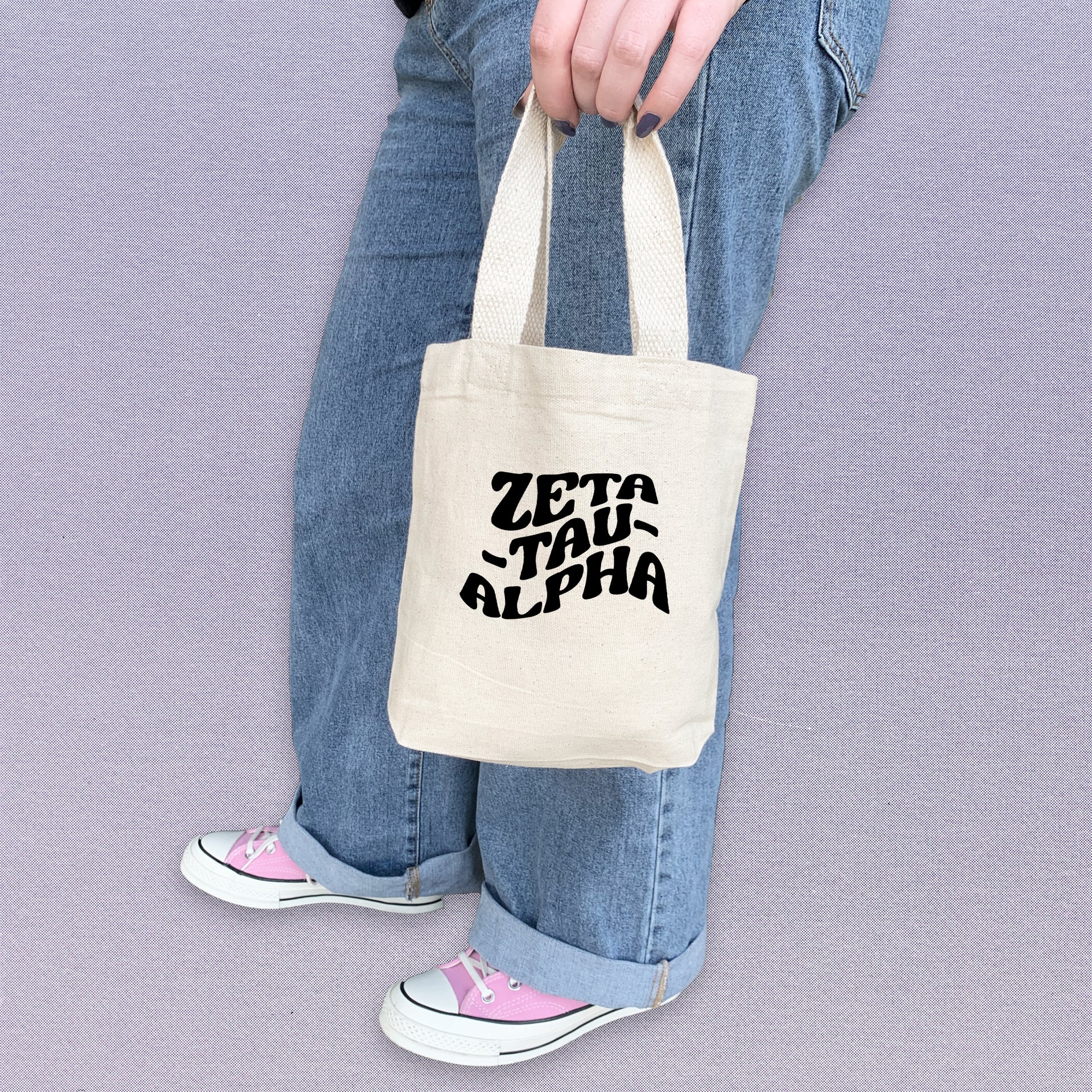 Zeta Tau Alpha member carrying a ZTA mini tote bag, ideal for gifting or everyday essentials.