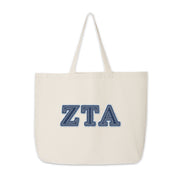 Zeta Tau Alpha tote bag featuring denim-style letters in a clean product shot.