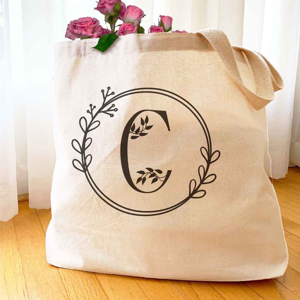 Large monogrammed bridesmaid tote bag personalized with a floral theme design.