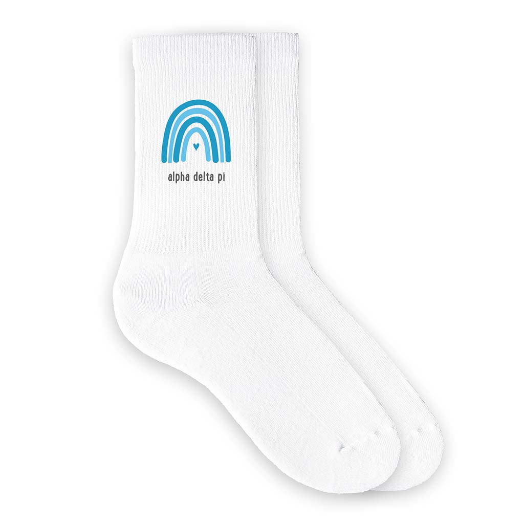 Alpha Delta Pi sorority name with rainbow blue hue sorority color design digitally printed on the side of the ribbed crew socks.