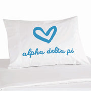 Alpha Delta Pi sorority name in handwriting with heart design digitally printed in sorority color ink on white cotton pillowcase.