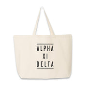 Sorority name in block capital letters with two lines on either side printed on canvas tote bag.