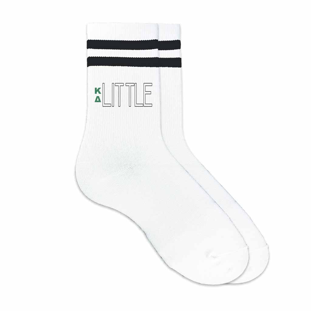 KD Greek letters digitally printed with big or little design on the outside of black striped crew socks.