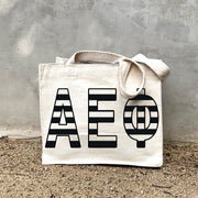 AEP Black Stripe In Black striped letters on a small canvas tote bag