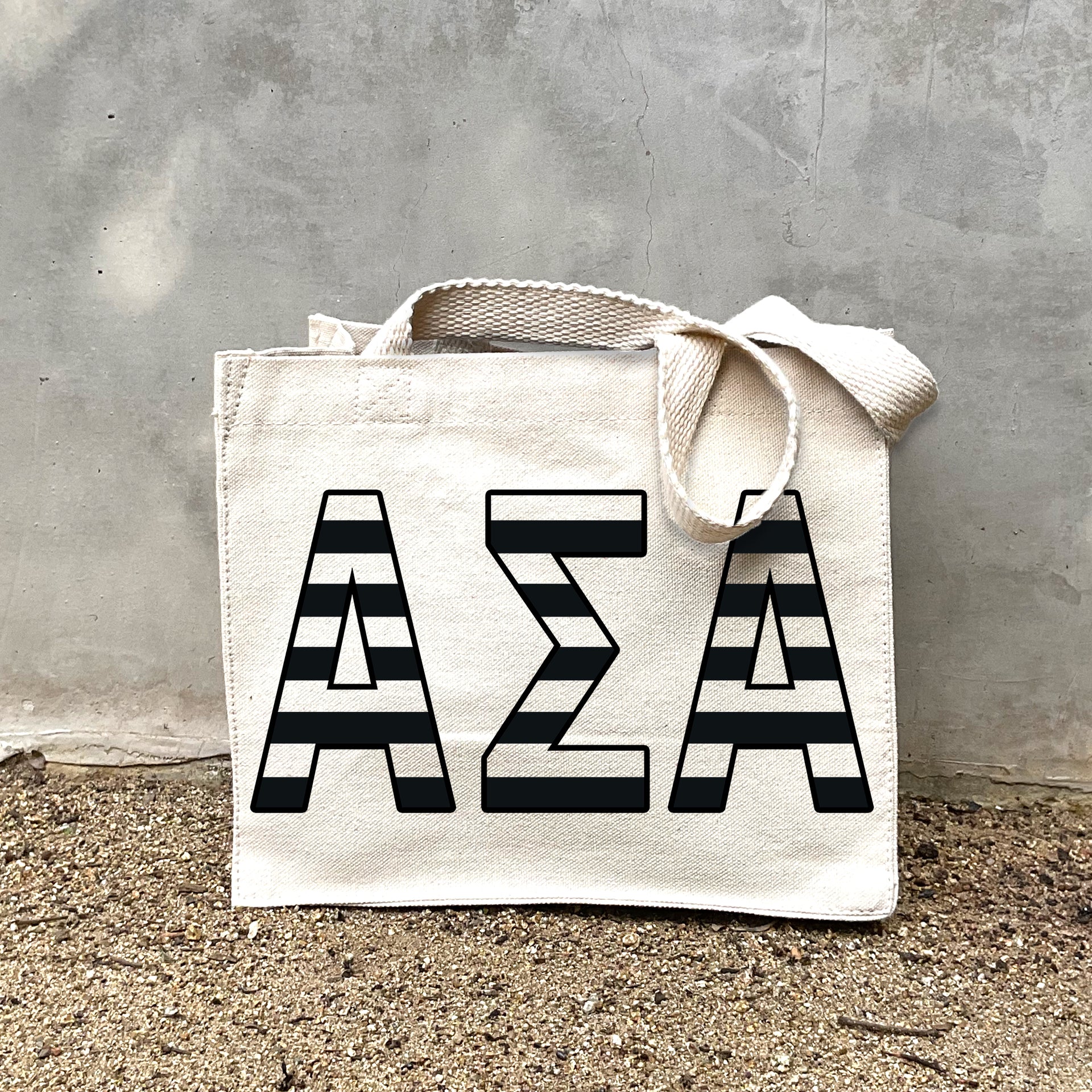ASA Black Stripe Tote in front of a gray wall