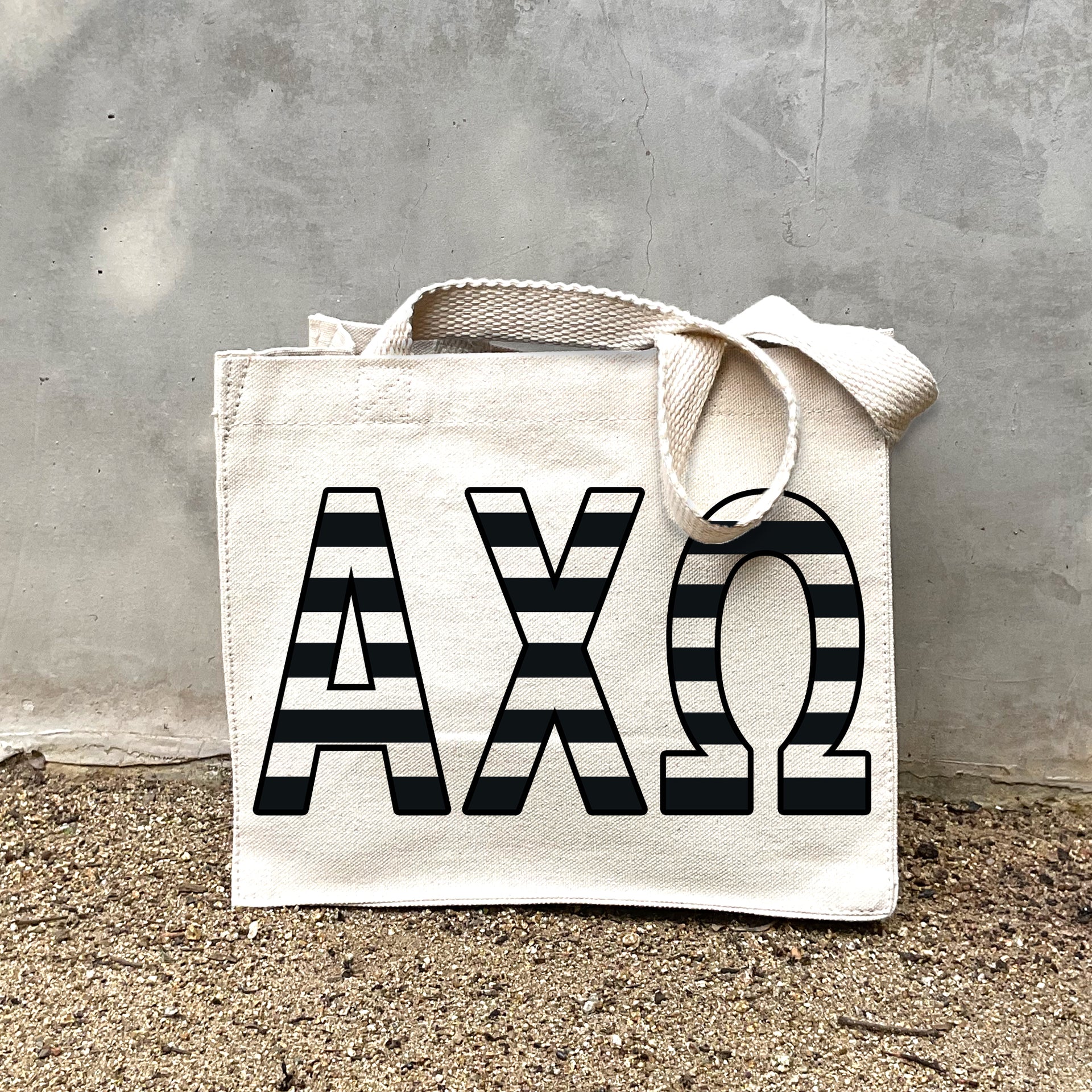 AXO Black Stripe Tote in front of a gray wall
