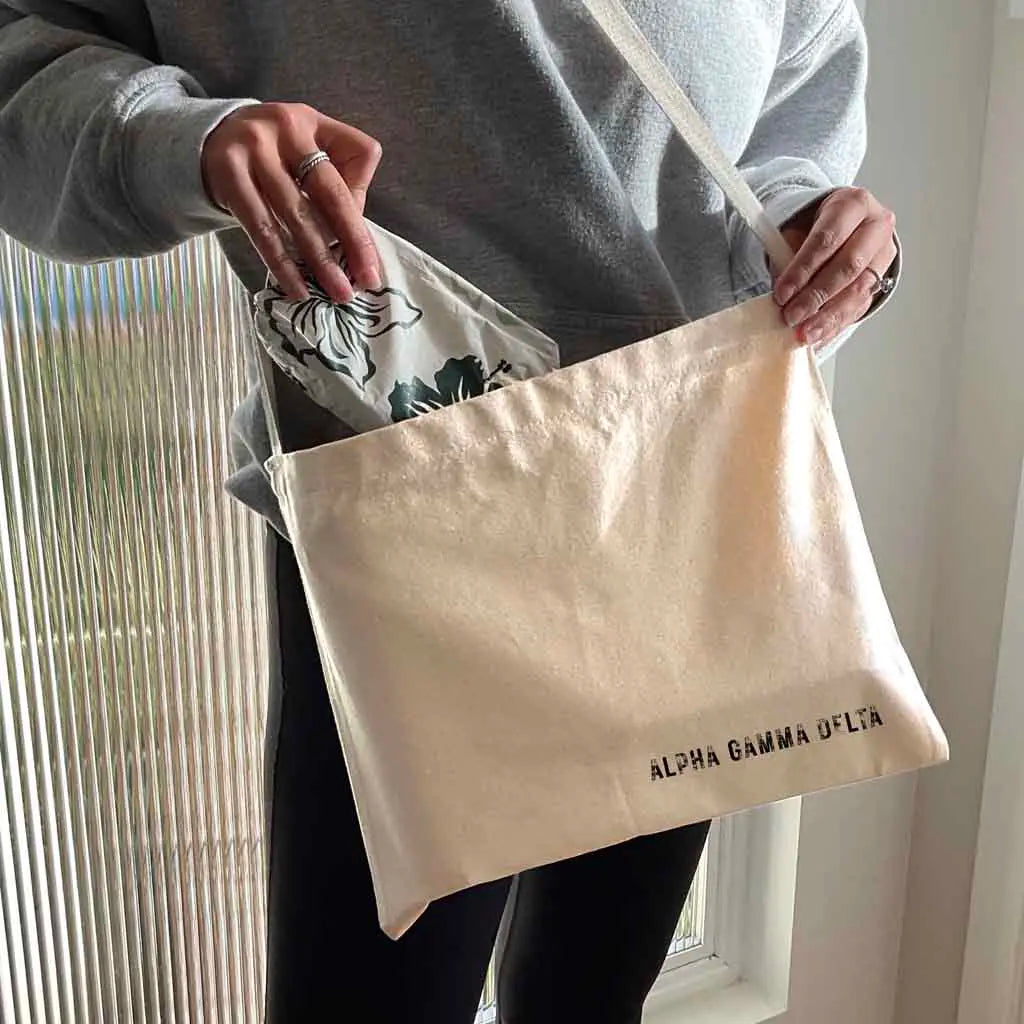 Crafted from durable canvas, each spacious bag features the Alpha Gamma Delta name digitally printed on both sides in the lower corner. Perfect for all your essentials, this carry-all silhouette is a fantastic gift idea and a favorite for chapter orders and big-little gifts.