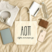 Alpha Omicron Pi small canvas tote bag with striped Greek letters styled in a flat lay with everyday essentials