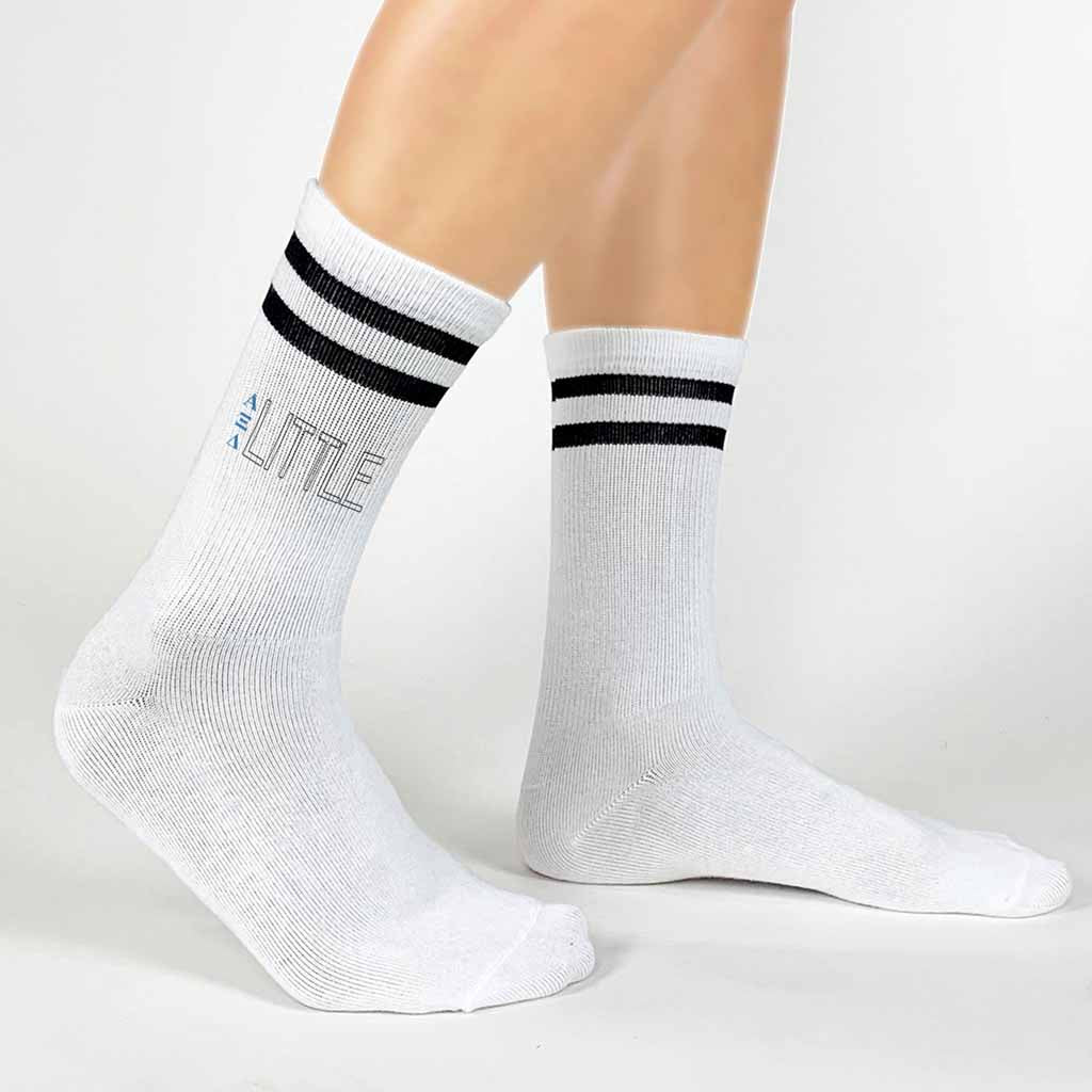 Soft and comfortable black striped cotton crew socks printed with AXID Greek letters and big or little design on the outsides of the socks.