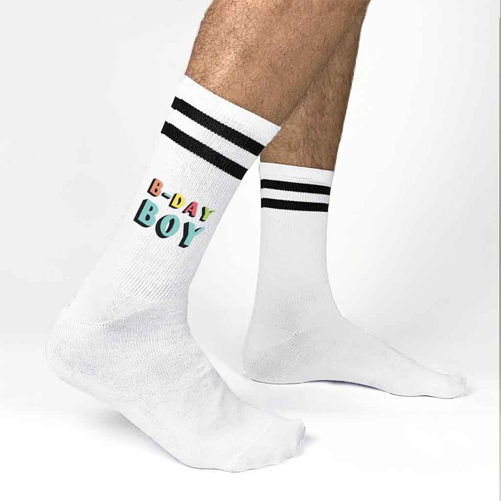 White socks with black stripes digitally printed with B-day Boy on the outside of both socks.