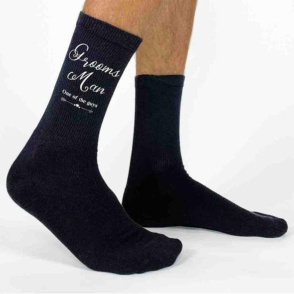 Cotton socks printed with grooms man wedding role and stylized with fun saying one of the guys printed on the outside of both socks.