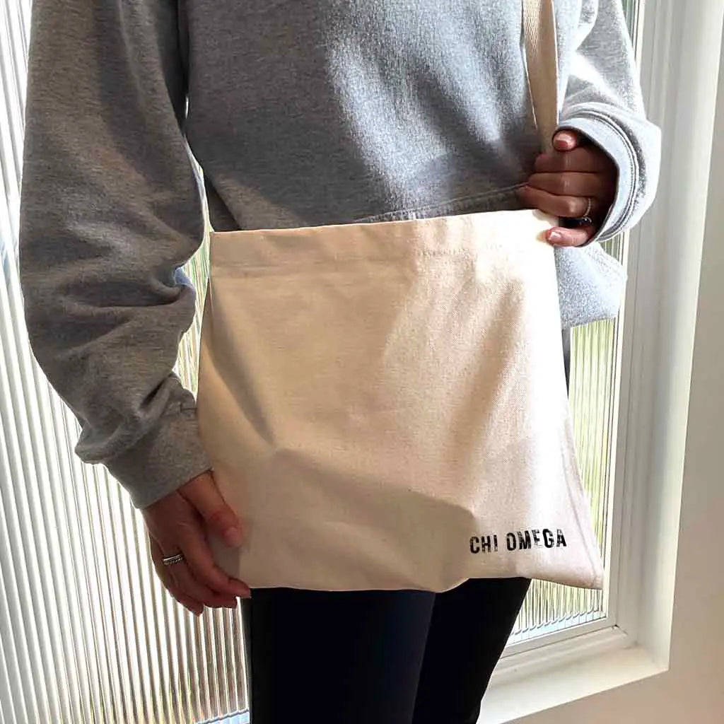 Crafted from durable canvas, each spacious bag features the Chi Omega name digitally printed on both sides in the lower corner. Perfect for all your essentials, this carry-all silhouette is a fantastic gift idea and a favorite for chapter orders and big-little gifts