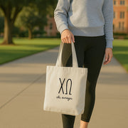 Chi Omega small tote displayed in a chapter lounge, personalized with Chi Omega's 3D Greek letters.