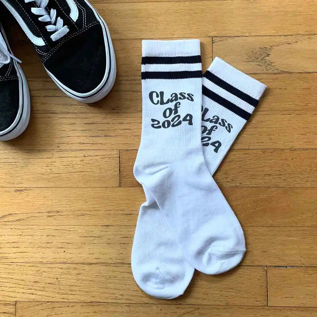 Class of 2024 custom printed in black ink on white cotton crew socks with black stripes are the perfect gift for your graduating senior.