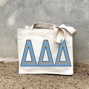 DDD Sorority Stripe Tote in front of a gray wall