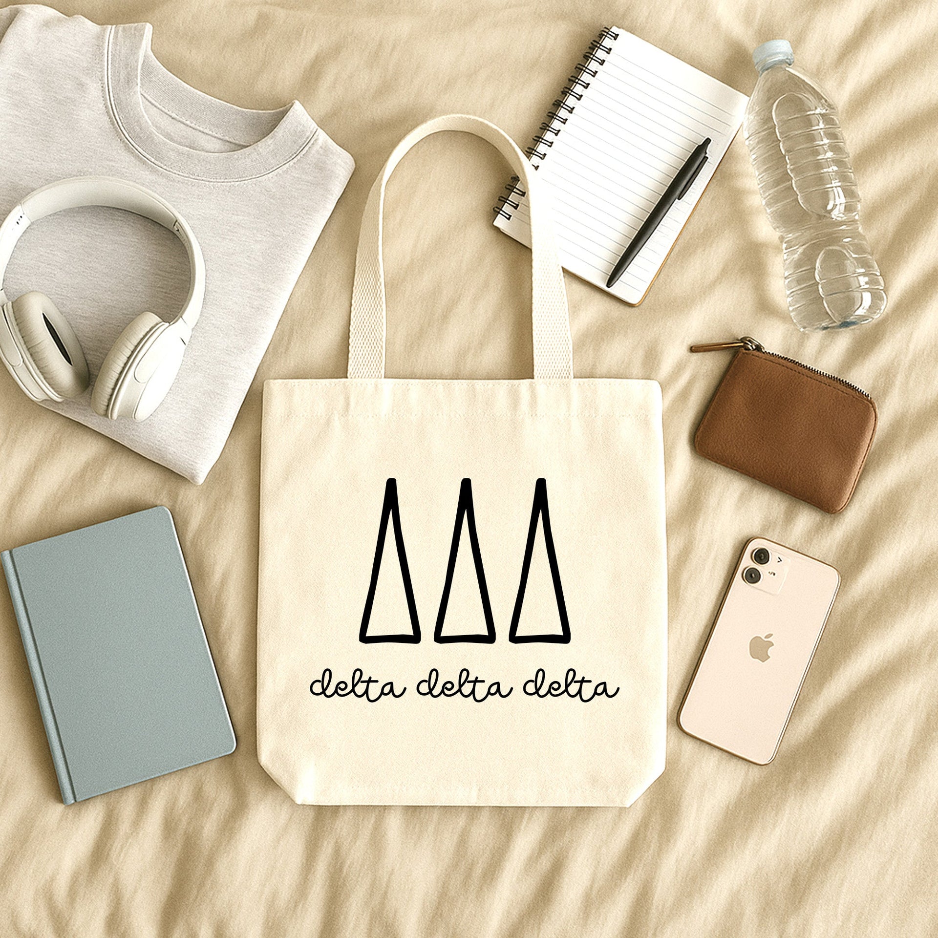 Delta Delta Delta member using her small sorority tote during a Big/Little gift exchange, printed with Tri Delta lettering.