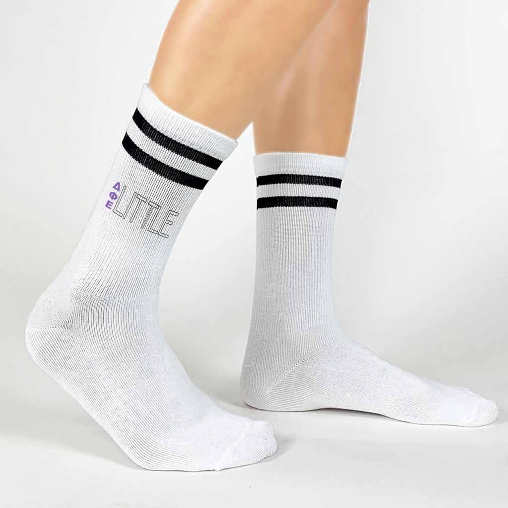 Comfy black striped crew socks digitally printed with Delta Phi Epsilon Greek letters and Big or Little design.