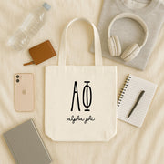 Alpha Phi lifestyle image of a sorority woman using her Alpha Phi tote during a sisterhood brunch or event.