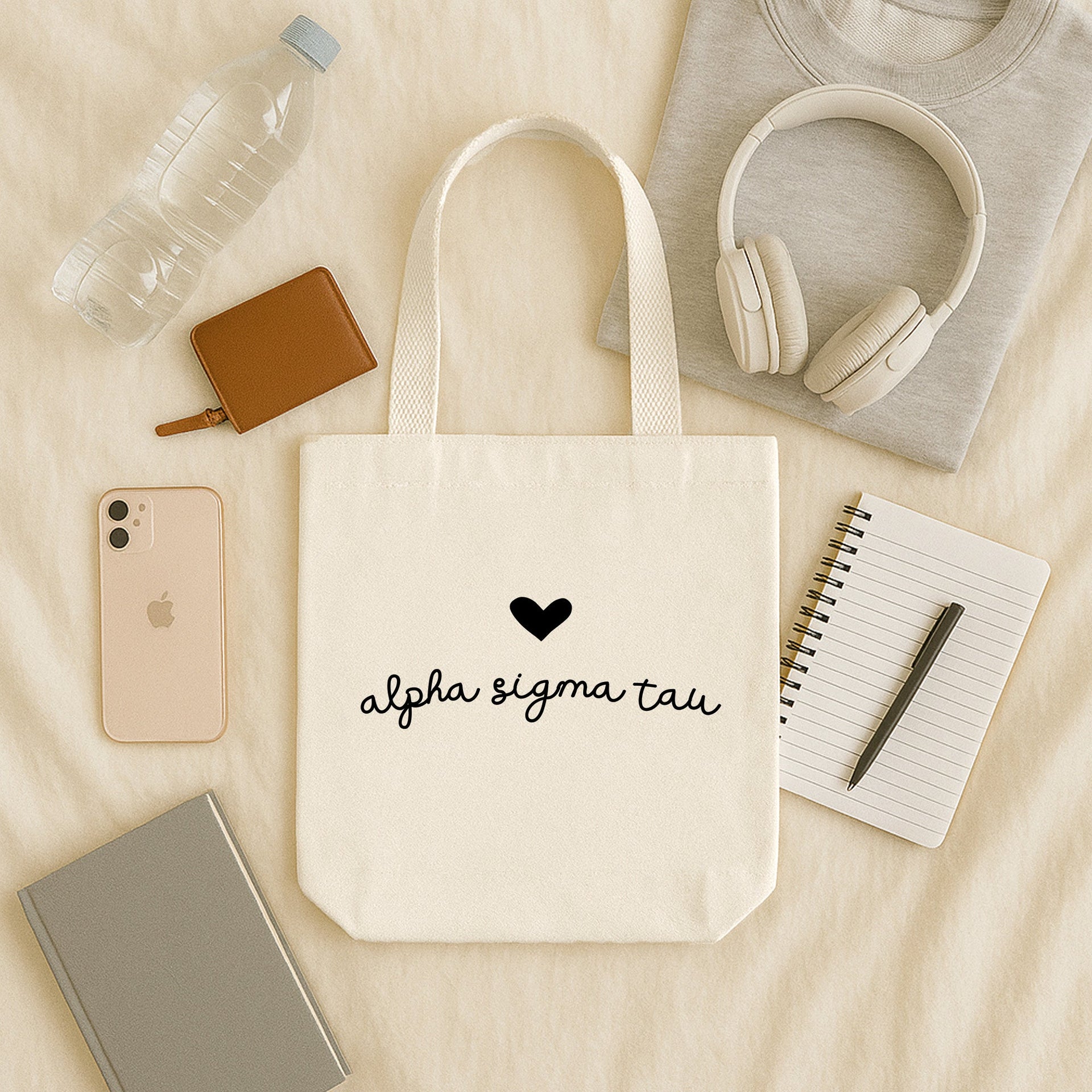 Alpha Sigma Tau sorority tote featuring heart and Greek letters, worn by a member walking to class.