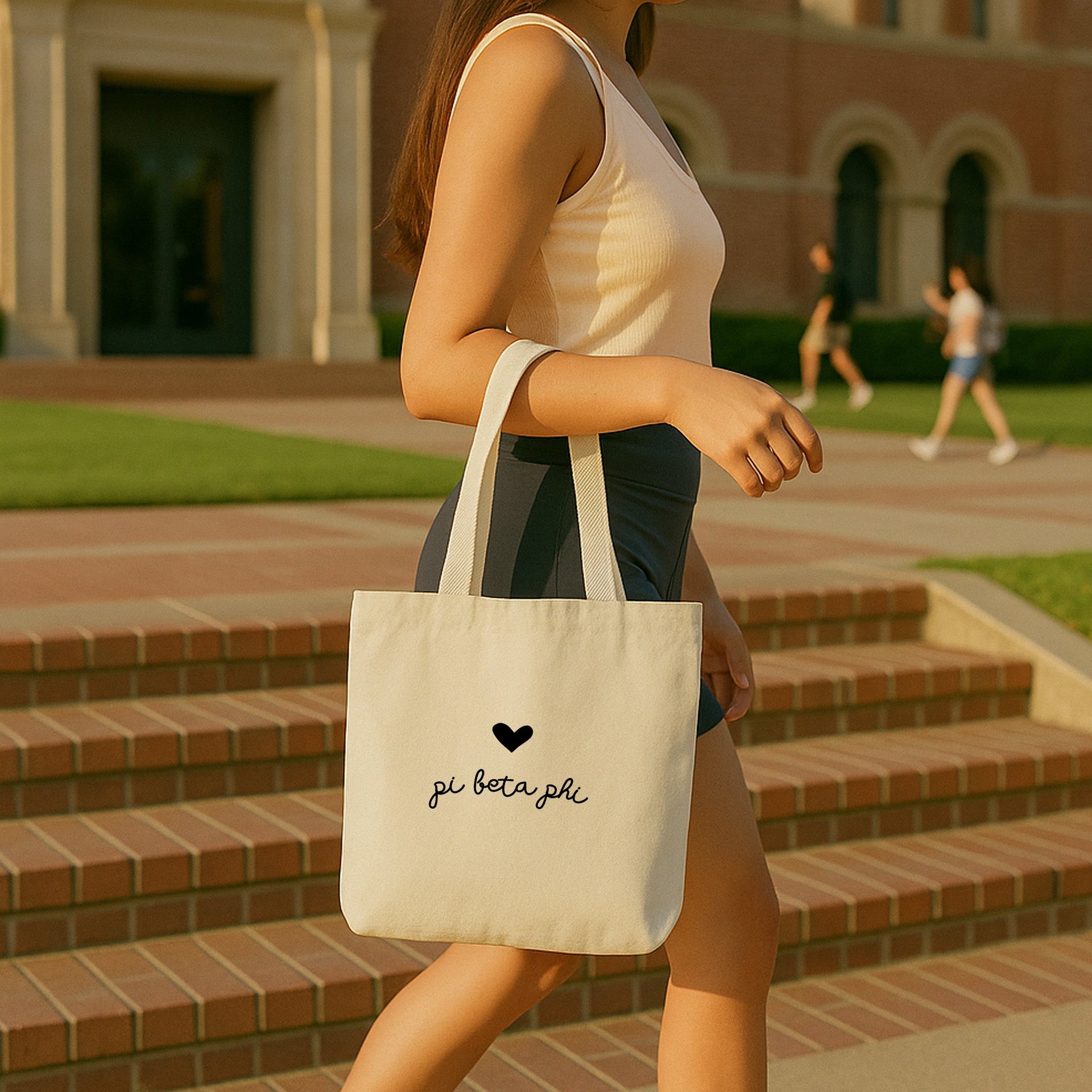 Pi Beta Phi heart and Pi Phi letters printed on a cotton canvas tote used at a chapter gift exchange.