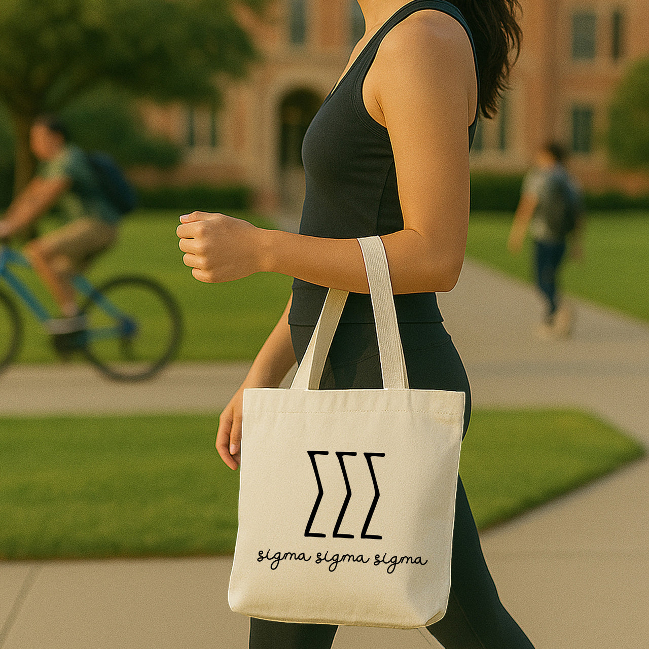 College student carrying a Sigma Sigma Sigma small canvas tote bag with striped Greek letters