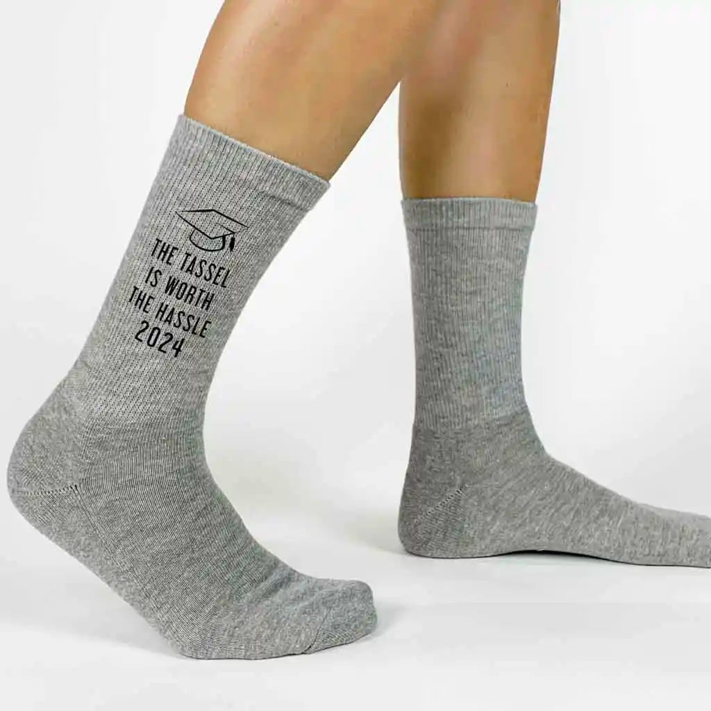 Funny 2024 graduation gift socks custom printed with class of 2024 TASSEL IS WORTH THE HASSLE printed on the outsides of both socks make a great gift for your graduating senior.