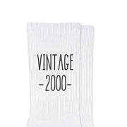 Happy Birthday socks with a vintage design printed with your year of birth on white cotton crew socks packaged with a cute gift box.