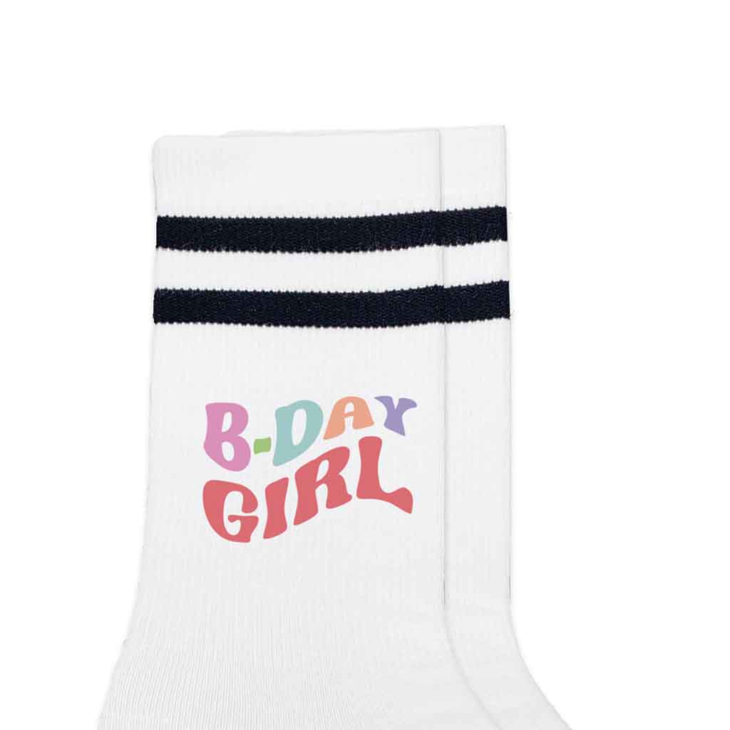 Fun Birthday girl socks digitally printed on the outside of white socks with black stripes.