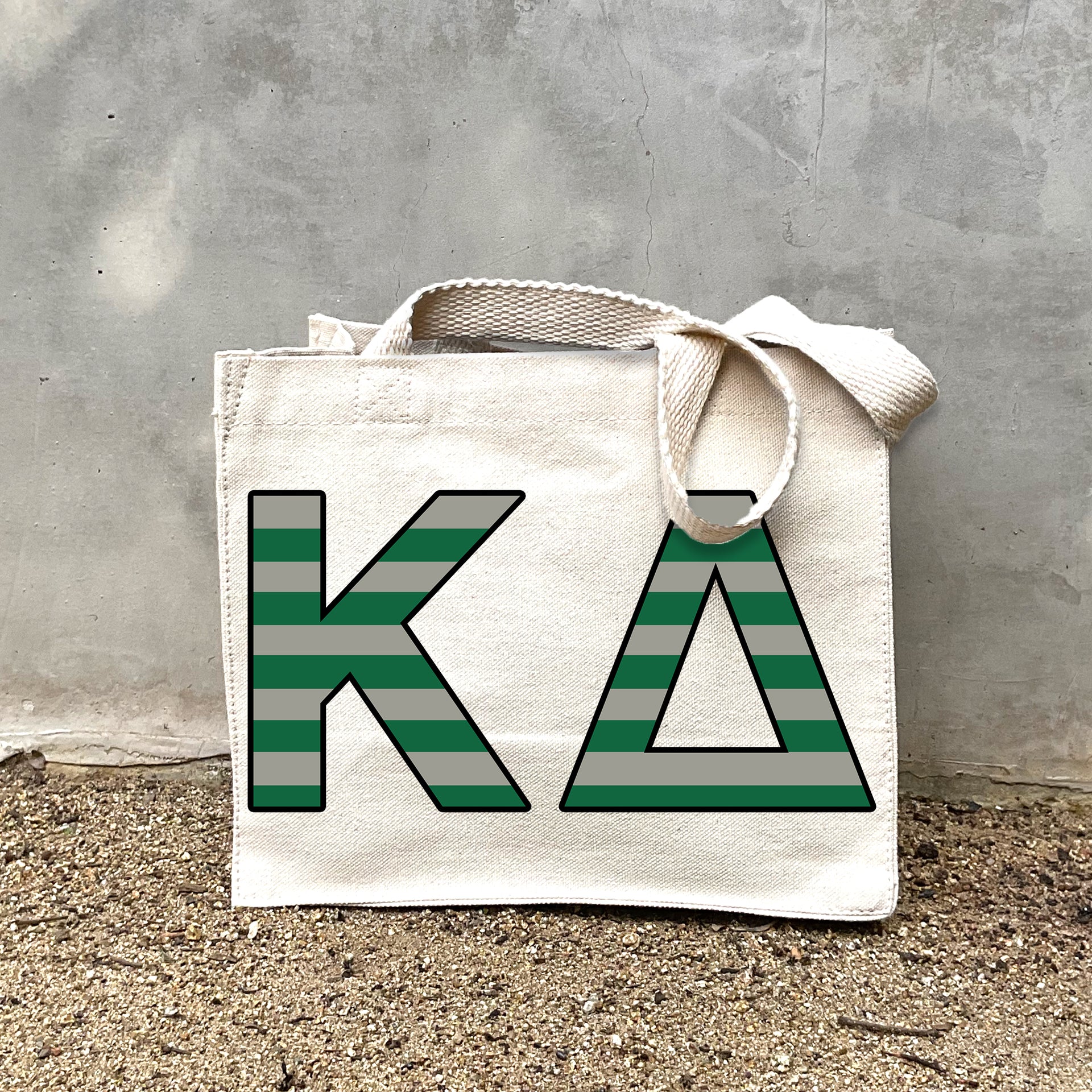 KD Black Stripe Tote in front of a gray wall