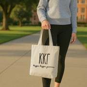 Kappa Kappa Gamma tote placed on a coffee table surrounded by friends, printed with Kappa Kappa Gamma's full name.