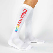 Comfortable white cotton knee high socks with a rainbow created equal design are the perfect accessory for pride month to show your support. 